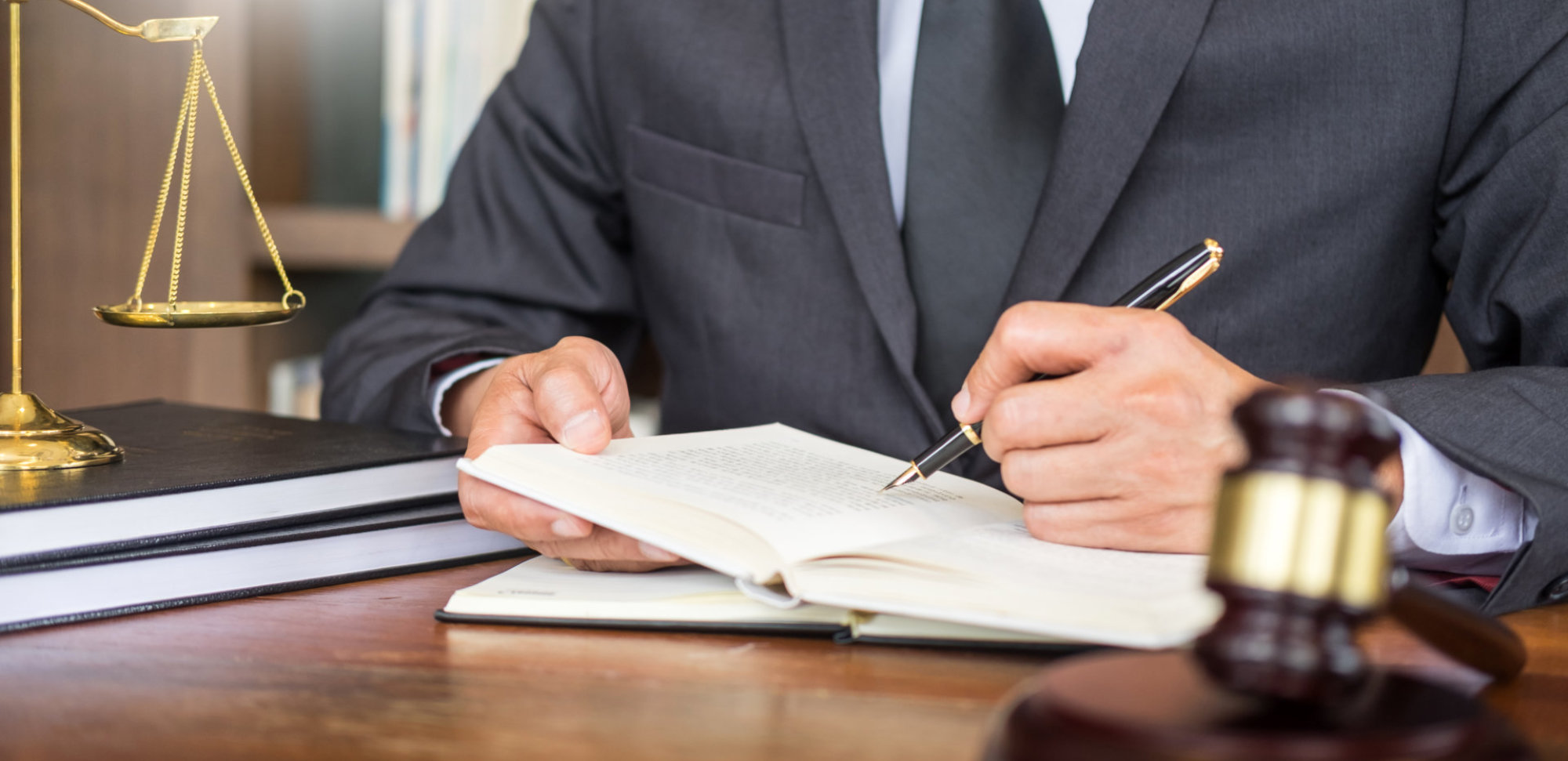 Attorney writing on a document